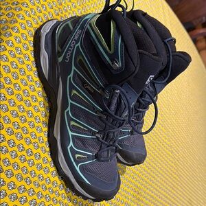 Salomon Black and Green Athletic Shoes with Rugged Design